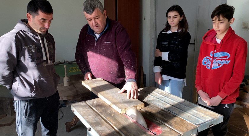 ოსტატი წეროვნიდან, რომელიც დევნილ ბავშვებს ხეზე კვეთას ასწავლის